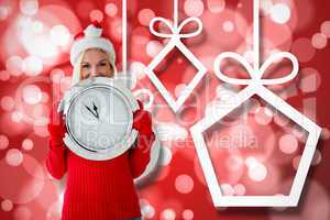 Composite image of happy festive blonde with clock