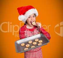 Composite image of festive little girl offering cookies