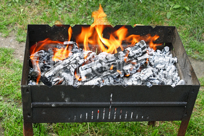 Fire in a container for cooking meat
