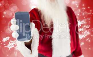 Composite image of santa claus showing smartphone