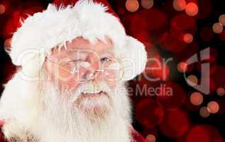 Composite image of santa claus winking