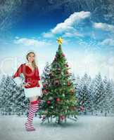 Composite image of pretty girl smiling in santa outfit