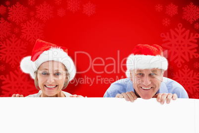 Composite image of festive couple showing poster