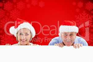 Composite image of festive couple showing poster