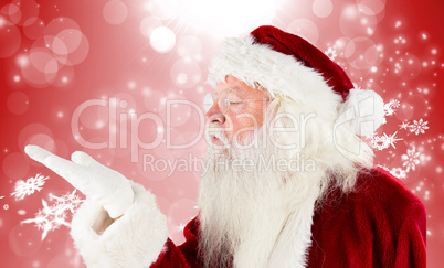 Composite image of santa claus blowing