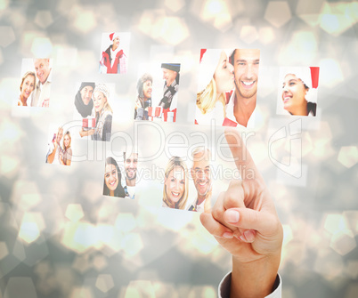 Composite image of hand pointing to christmas people collage