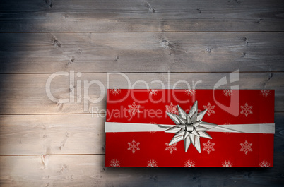 Composite image of christmas present with bow