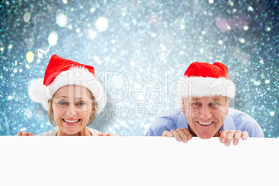 Composite image of festive couple showing poster