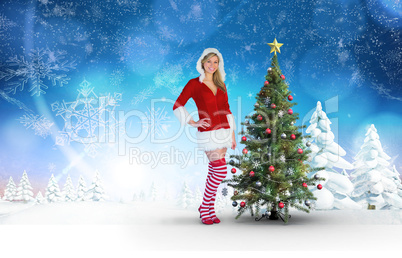 Composite image of pretty girl smiling in santa outfit