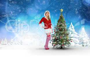 Composite image of pretty girl smiling in santa outfit