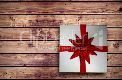 Composite image of christmas present with bow