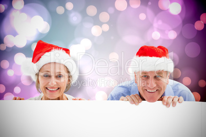 Composite image of festive couple showing poster