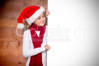 Composite image of festive little girl showing card