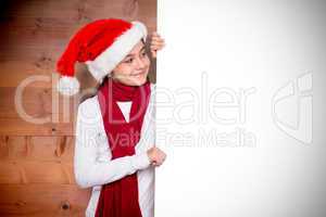 Composite image of festive little girl showing card