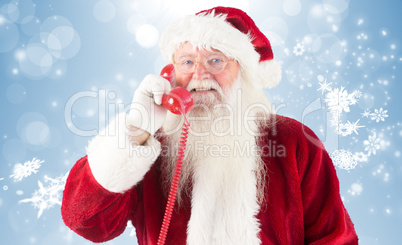 Composite image of santa claus on the phone