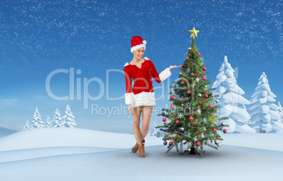 Composite image of pretty santa girl presenting with hand