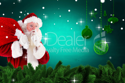 Composite image of santa claus carrying sack