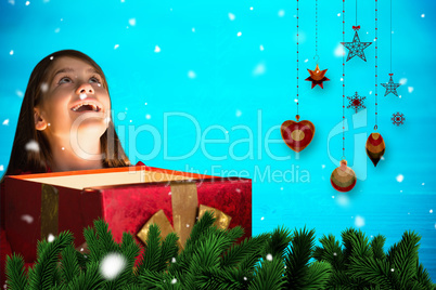 Composite image of happy girl opening gift box