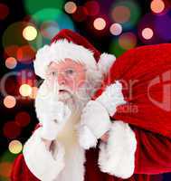 Composite image of santa claus carrying sack