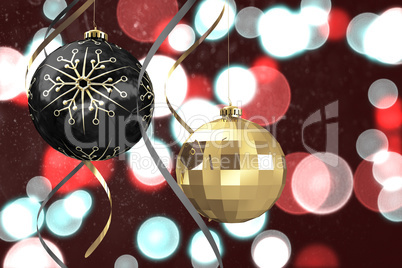 Composite image of hanging christmas bauble decorations