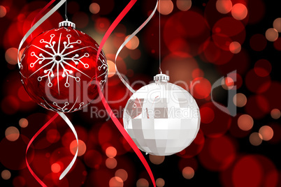 Composite image of hanging christmas bauble decorations