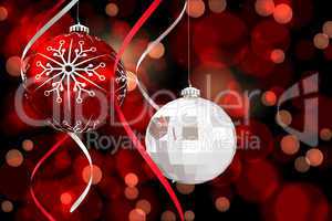 Composite image of hanging christmas bauble decorations