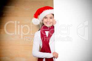 Composite image of festive little girl showing card