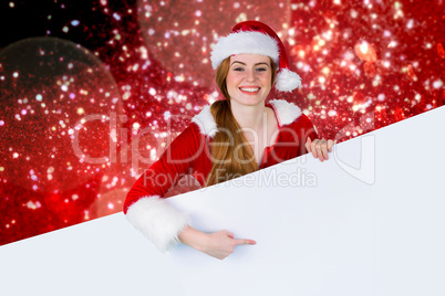 Composite image of pretty girl in santa costume showing card