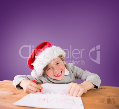 Composite image of festive boy writing letter