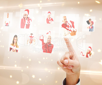 Composite image of hand pointing to christmas people collage