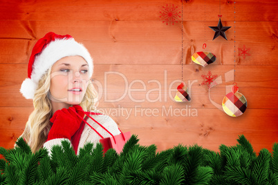 Composite image of happy festive blonde with shopping bag