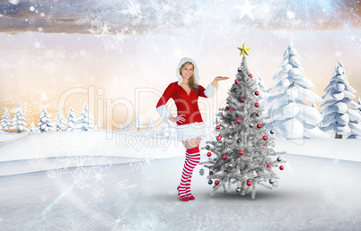 Composite image of pretty girl presenting in santa outfit