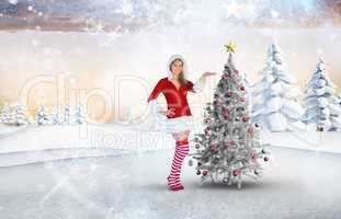 Composite image of pretty girl presenting in santa outfit