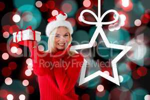 Composite image of happy festive blonde with gift