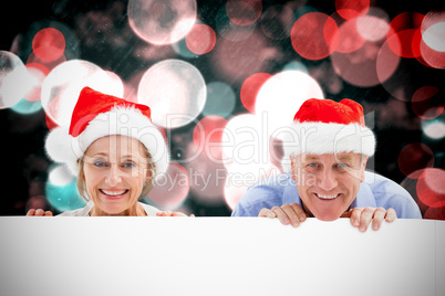 Composite image of festive couple showing poster