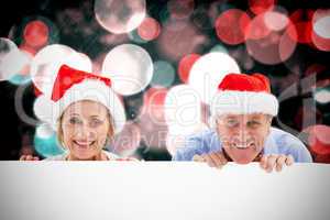 Composite image of festive couple showing poster