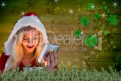 Composite image of sexy santa girl opening gift