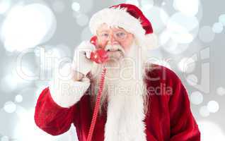 Composite image of santa claus on the phone