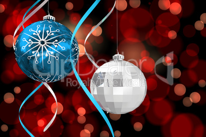 Composite image of hanging christmas bauble decorations