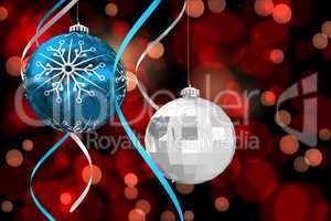 Composite image of hanging christmas bauble decorations