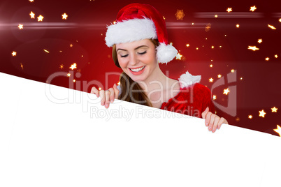 Composite image of pretty girl in santa costume showing card