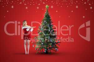 Composite image of pretty girl presenting in santa outfit