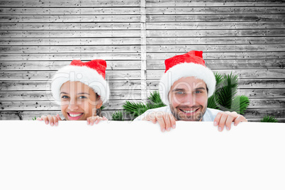 Composite image of festive young couple smiling at camera