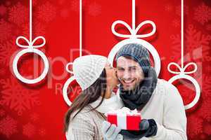 Composite image of winter couple holding gift