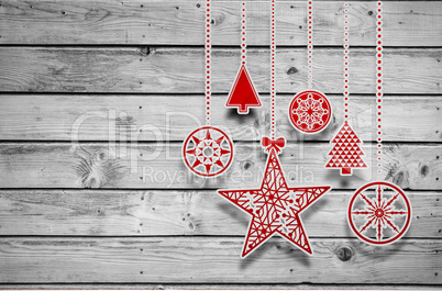 Composite image of hanging red christmas decorations