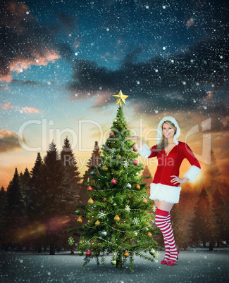 Composite image of pretty girl presenting in santa outfit