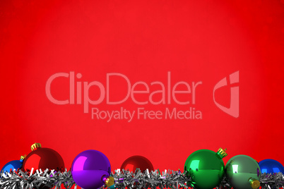 Composite image of christmas baubles and tinsel