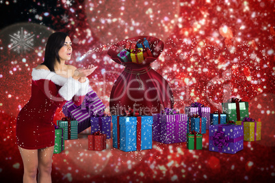 Composite image of pretty girl in santa outfit blowing