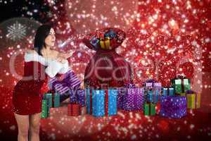 Composite image of pretty girl in santa outfit blowing