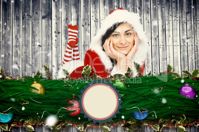 Composite image of pretty girl smiling in santa outfit